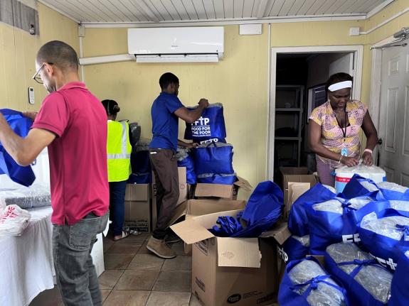 Food For The Poor Jamaica team members arrange packages and emergency supplies to assist those affected by Hurricane Melissa.