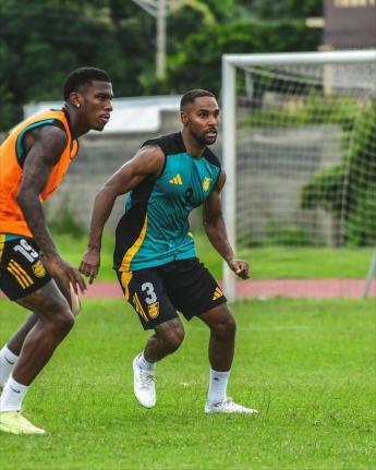 Reggae Boyz Dujuan ‘Whisper’ Richards (left) and debutant Rico Henry facee off during a training session in Trinidad and Tobago earlier this week.