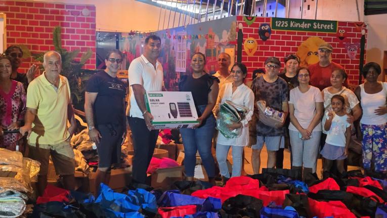 St James Southern Member of Parliament Nickeisha Burchell (fourth left) accepts a solar street light from Bhasker Reddy Sharu and members of the Montego Bay Indian community last Friday at the Heinz School in Montego Bay.