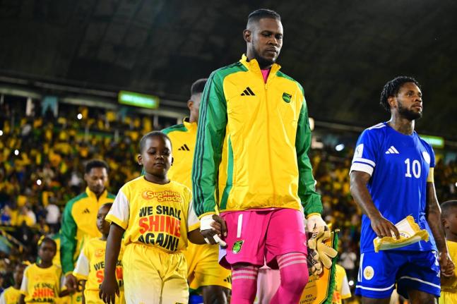 Reggae Boyz captain Andre Blake (left) leads his team out ahead of last Tuesday’s final Concacaf Group B World Cup Qualifying match at the National Stadium. Jamaica drew 0-0 with Curacao and failed to earn an automatic spot in the 2026 World Cup. 