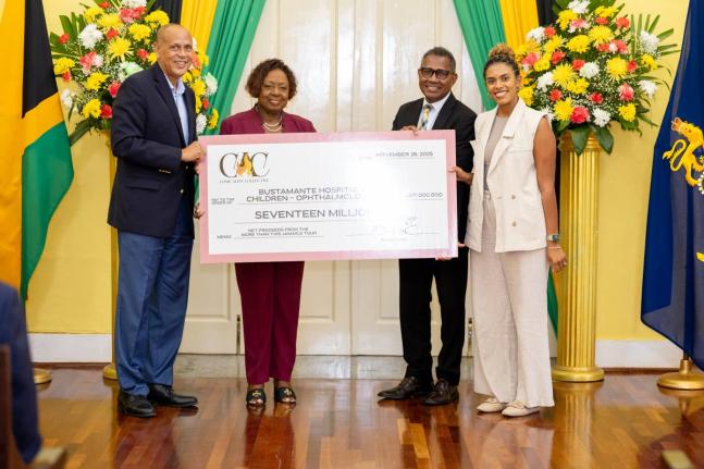 From left: Eric Hosin, chairman of the Come Alive Collective, and Olivia ‘Babsy’ Grange, minister of culture, gender, entertainment and sport, present the symbolic cheque to Anthony Wood, chief executive officer of the Bustamante Hospital for Children,