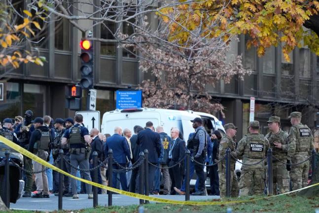 Emergency personnel gather in a cordoned off area where National Guard soldiers were shot near the White House Wednesday, November 26, 2025, in Washington. (AP Photo/Mark Schiefelbein)