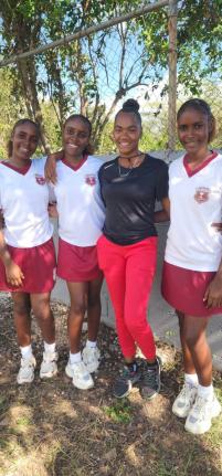 Photo by Raymond Graham
Kellits High school’s netball players Shanay (left), Sheamoy (second left), and Shenelle Stewart (right) pose with their coach, Alaine Rochester just after their ISSA Rural Under-16 match against Denbigh High School on Thursday. 