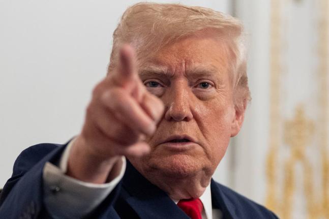 President Donald Trump speaks to reporters after speaking to troops via video from his Mar-a-Lago estate on Thanksgiving, Thursday, November 27, 2025, in Palm Beach, Florida.(AP Photo/Alex Brandon)