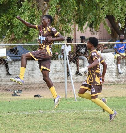 Charlie Smith’s Anthony Bryan (left) and Kevin Howell celebrate the former’s opening goal against St Catherine High during their Manning Cup football match at St George’s College yesterday. Charlie Smith won 4-1.