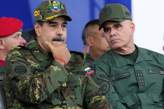 Venezuelan President Nicolas Maduro (left) listens to Defense Minister Vladimir Padrino López during a government-organised civic-military march in Caracas.