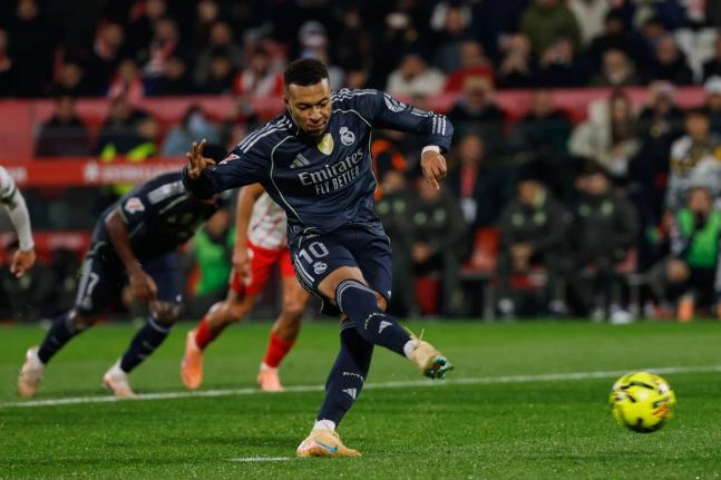 Real Madrid’s Kylian Mbappe scores a penalty kick during a Spanish La Liga match between Girona and Real Madrid, in Girona, Spain, yesterday.