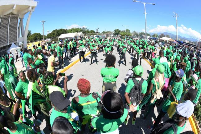 In this 2019 photo onlookers gather to watch the Mighter Flyers Marching Band perform outside the National Arena,  venue of the JLP Annual Conference.