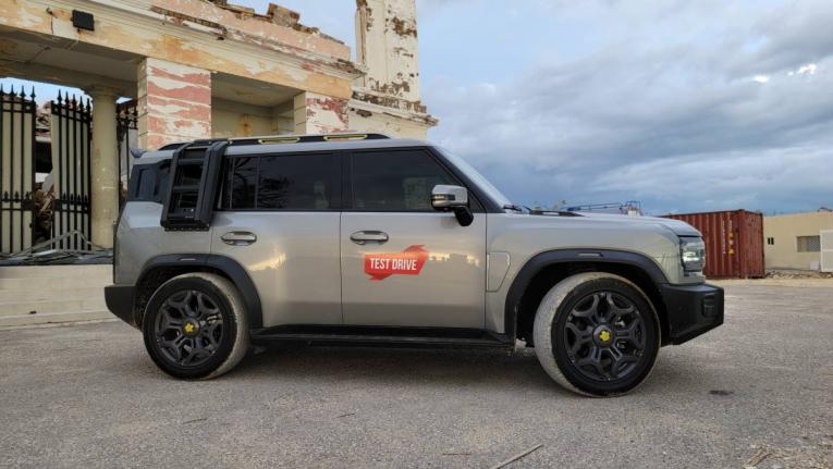 Defined profile view highlighting the purposeful square design and the practical utility of the optional external ladder and roof box.