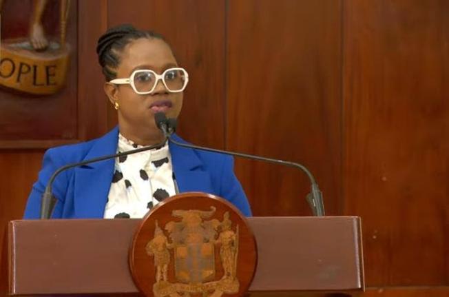 Students' Loan Bureau Executive Director Nickeisha Walsh speaking at a press conference at Jamaica House on December 3, 2025.