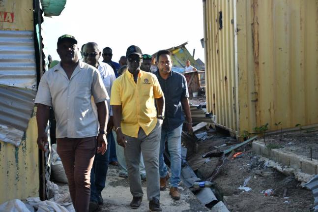 Minister of Local Government and Community Development Desmond McKenzie (second left) tours a section of the Savanna-La-Mar Market in Westmoreland last Wednesday to assess the damage caused by the recent passage of Hurricane Melissa. Joining him are (from 