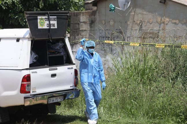Forensic personnel is seen at a scene where bodies of the victims of a mass shooting where found at a bar near Pretoria, South Africa, Saturday, December 6, 2025. (AP Photo)