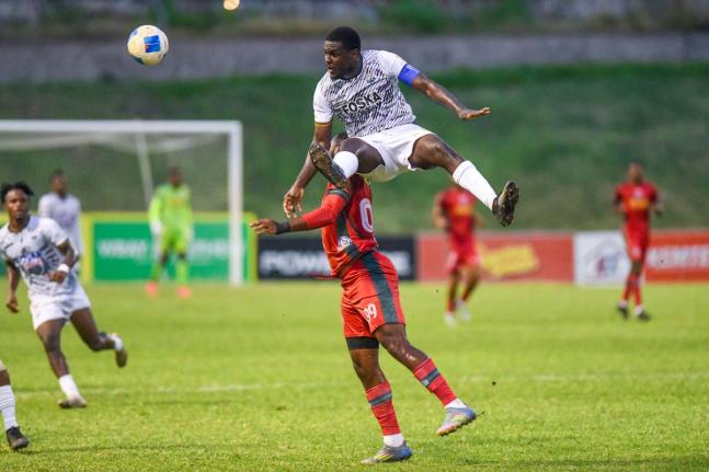 Cavalier skipper Jeovanni Laing (right) produces a towering header ahead of Mount Pleasant’s Brian Lee Brown during a Jamaica Premier League match at the Stadium East field yesterday.