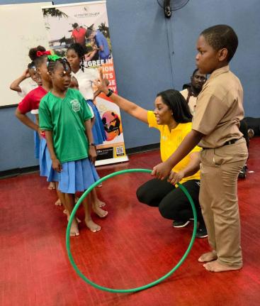 Dance Professor Renee Walters (second right) guides children through an activity at the GC Foster College’s inaugural Play for Recovery day at the school grounds yesterday.