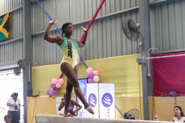 Alana Walker balances well on the beam as she competes in the recent Mayberry Investments Gymnastics Championships at the Jamaica College Auditorium. 