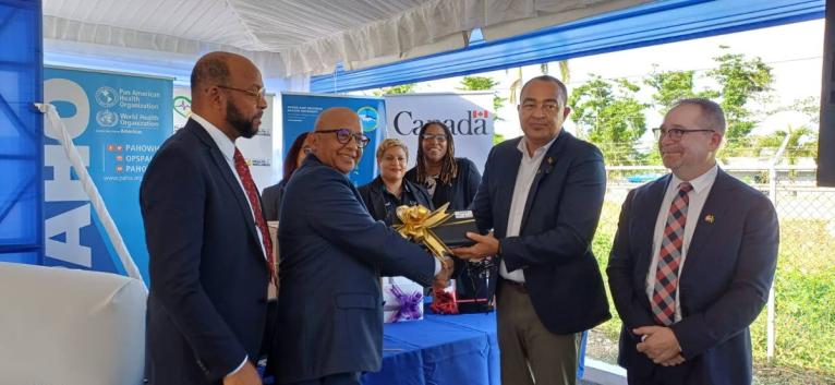 Health and Wellness Minister, Dr Christopher Tufton (second right), accepts Electronic Immunisation Registry equipment from Monitoring and Evaluation Specialist at UNICEF, Dr Paul Edwards (second left), during a handover ceremony held at the St Ann Healt