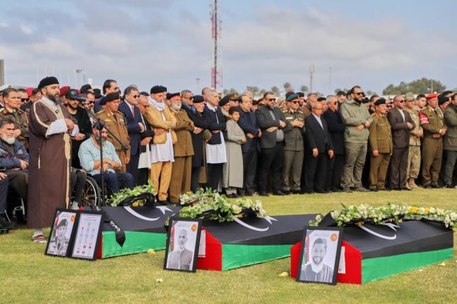 People attend funeral prayers for General Muhammad Ali Ahmad al-Haddad, coffin at left, in Misrata, Libya, who was killed with others in a plane crash.
