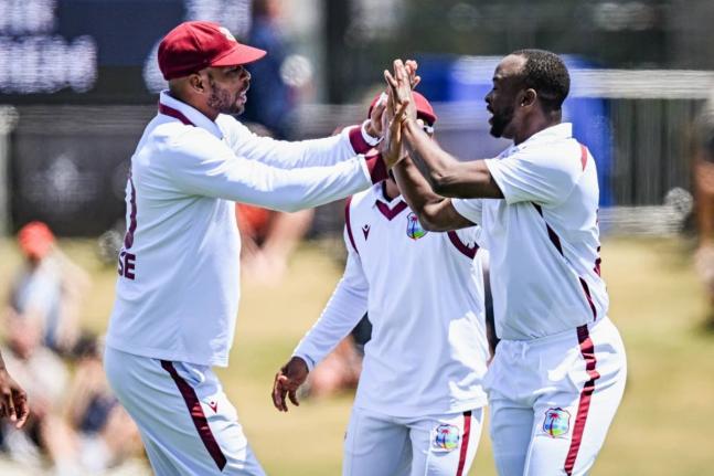 West Indies fast bowler Kemar Roach (right) and captain Roston Chase celebrate the wicket of New Zealand’s Kane Williamson during the recent first Test match between the two teams  in Christchurch, New Zealand, on Thursday, December  4. 