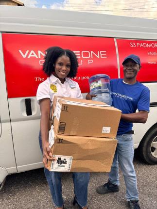 Lifespan Brand Manager Karonna Atkins (left) shares a moment with Glenville McDonald of partner hosts Vantage One Group during a recent outreach. The collaboration aims to uplift residents through health checks, mental health support, games, entertainment,