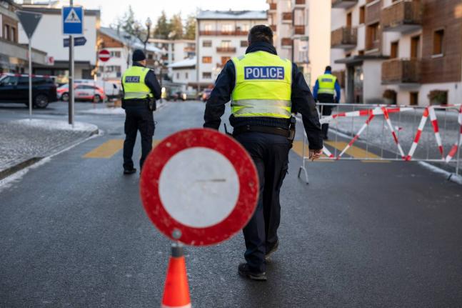Police officers inspect the area where a fire broke out at the Le Constellation bar and lounge leaving people dead and injured, during New Year’s celebration, in Crans-Montana, Swiss Alps, Switzerland, Thursday, January 1, 2026. (Alessandro della Valle/K