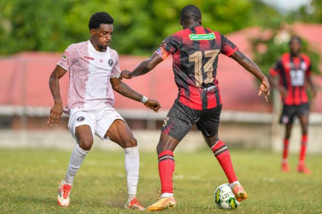 Damoi Kaschief Whitfield (left) of Chapelton Maroons tries to stop the advance of Fabian Reid of Arnett Gardens during a Jamaica Premier League match at Turner’s Oval in Clarendon on September 14, 2025.