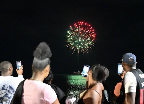 Residents watch as fireworks light up the seafront for the first time in Black River, St Elizabeth, during the New Year’s fireworks show staged by the Urban Development Corporation.