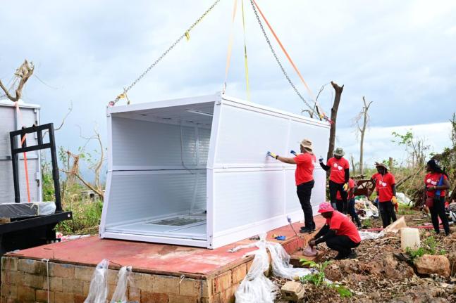 Volunteers install a container house for mother of six, Ashella Baker, in Middle Quarters, St Elizabeth recently.