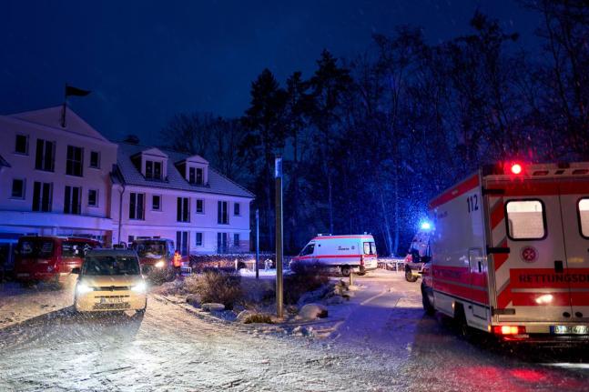 Emergency vehicles from the aid organisation “Die Johanniter” pick up residents of a retirement home in Berlin, during a power cut after a fire on a cable bridge. 