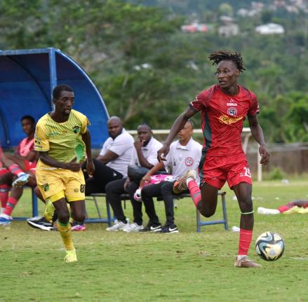 
Montego Bay United’s Deonjay Brown (right) dribbles away from Treasure Beach FC’s Chandol Anderson during their Jamaica Premier League football match at St Elizabeth Technical High School on January 4.