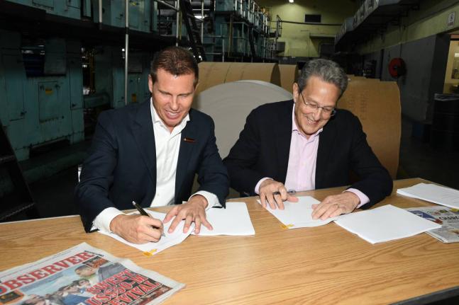 Executive Chairman of Jamaica Observer Limited Adam Stewart (left), and Executive Chairman of RJRGLEANER Communications Group Joseph Matalon sign the joint-venture agreement that set the foundation for the establishment of North Beech Limited – the new e
