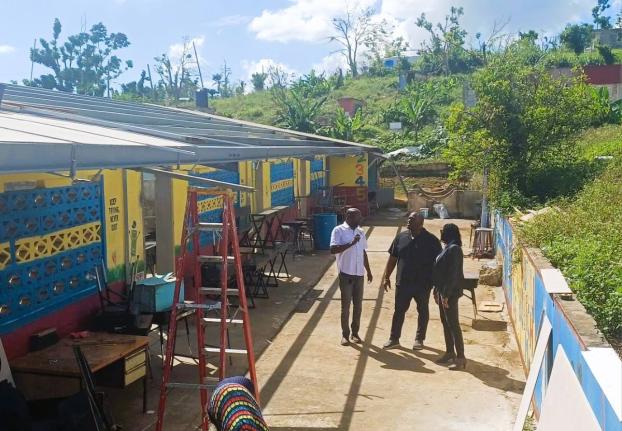Senator Marlon Morgan (centre), parliamentary secretary in the Ministry of Education, Skills, Youth and Information; Susan Nelson Smith (right), regional director at the ministry for Region Five; and Dameon Sinclair, managing director at the Southern Contr