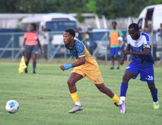 
Racing United’s Kadean Young (left) runs away from Mount Pleasant Academy’s Clifford Thomas during their Jamaica Premier League game at the Drax Hall Sports Complex on January 11.