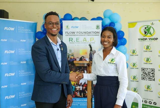 Executive Director of the Flow Foundation Rhys Campbell and Executive Director of the Young Women and Men on Purpose initiativ, Lanisia Rhoden seal their agreement with a handshake at the launch of the Flow Foundation REAP Entrepreneurial programme on Janu