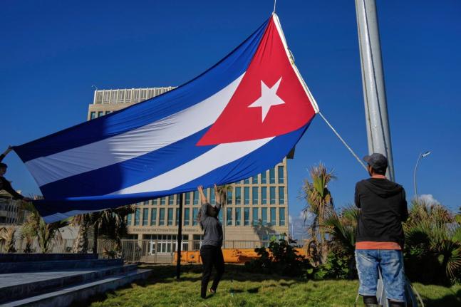 Workers fly the Cuban flag at half-staff at the Anti-Imperialist Tribune near the US Embassy in Havana, Cuba on January 5, 2026, in memory of Cubans who died two days before in Caracas, Venezuela during the capture of Venezuelan President Nicolas Maduro by