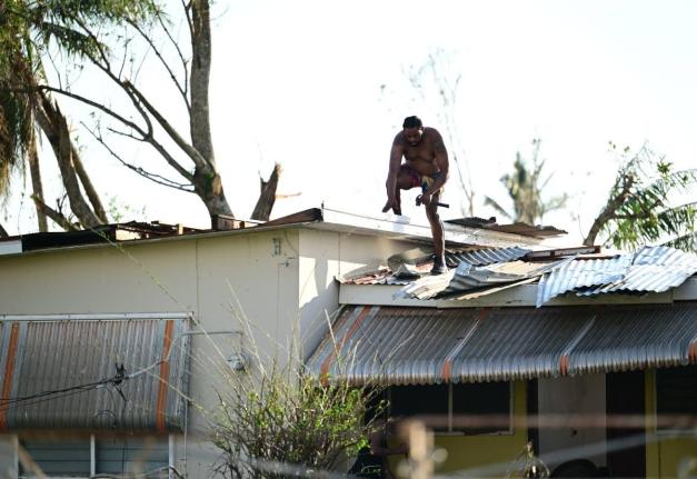 A homeowner in Black River, St Elizabeth, is seen repairing the roof of his house, which was destroyed by Hurricane Melissa last October.