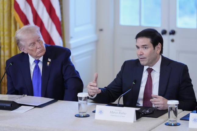 President Donald Trump listens to Secretary of State Marco Rubio speak during a meeting with oil executives in the East Room of the White House.