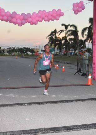 Defending Champion, male, Brandon Kerr crosses the finish line in 17:33, winning the Kiwanis Club of Providence-Montego Bay Breast Cancer 5K Run, Walk and Wheelchair for the second year on Sunday at the Fairview Office Complex.