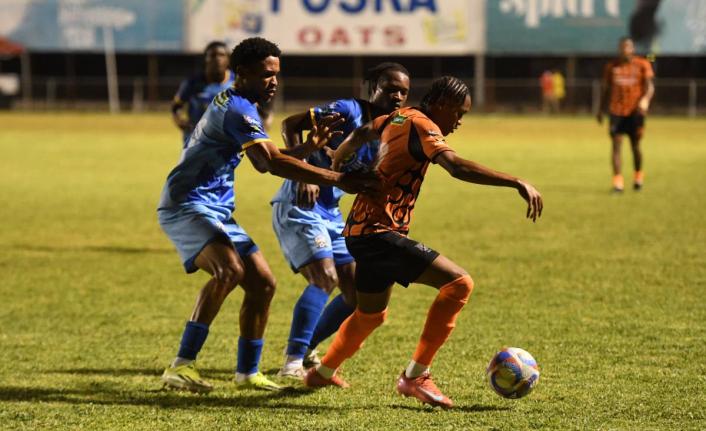 Tivoli Gardens’ Nickalia Fuller (right) tries to evade the attentions of Molynes United’s Odane Murray (left) and Tyrique Wilson during a Jamaica Premier Leaue fixture at the Anthony Spaulding Sports Complex in Kingston on Monday. 