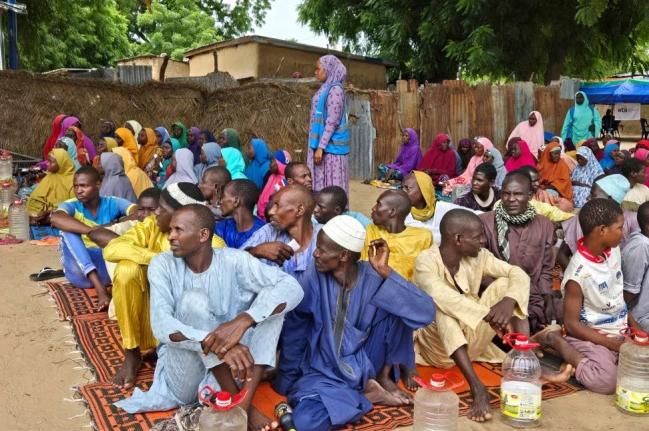 People wait to receive food donations from the United Nations World Food Program in Damasak, northeastern Nigeria, October 6, 2024. 