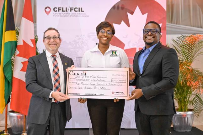 Patron of the Save our Boys and Girls Foundation and Member of Parliament for St Andrew East Rural, Juliet Holness (centre), and EduFocal co-founder and Chief Executive Officer (CEO), Gordon Swaby (right), receive a cheque from High Commissioner of Canada 