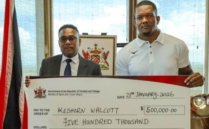 World champion Keshorn Walcott (right) accepts his award from Trinidad and Tobago’s Minister of Sport and Youth Affairs, Phillip Watts.
