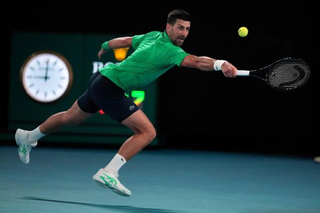 Novak Djokovic of Serbia plays a backhand return to Botic van de Zandschulp of the Netherlands during their third round match at the Australian Open tennis championship in Melbourne, Australia on January 24, 2026. 