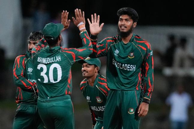 
Bangladesh’s Rishad Hossain, right, is congratulated by teammate Mahmudullah after dismissing Australia’s Travis Head during the ICC Men’s T20 World Cup cricket match between Australia and Bangladesh in North Sound, Antigua and Barbuda, Thursday, Ju
