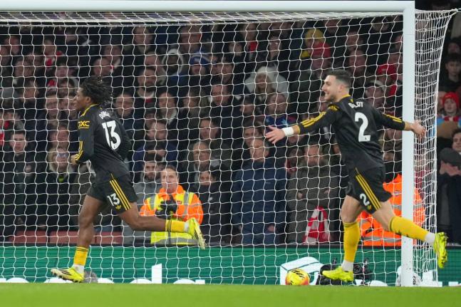 Manchester United's Patrick Dorgu (left) celebrates scoring his side's second goal during the English Premier League football match between Arsenal and Manchester United in London on January 25, 2026. 