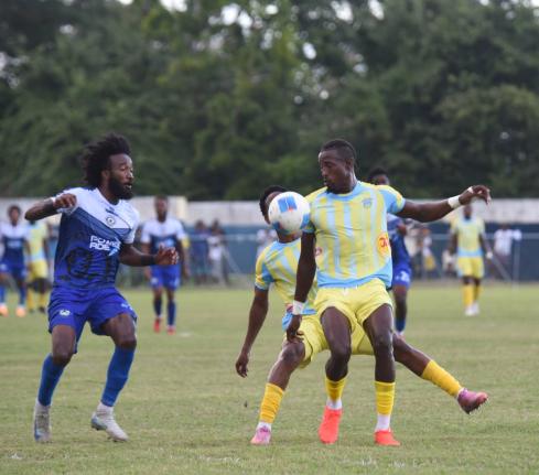 Waterhouse FCs Javane Bryan (right) tries to get past Mount Pleasant Academy’s Demario Phillips (left) during their Jamaica Premier League game at Drax Hall Sports Complex in St Ann yesterday.
