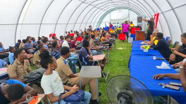 Teachers and student-athletes from the Manning’s School, Frome Technical, Petersfield High, and Godfrey Stewart High listen to a presentation from the Jamaica Athletics Administrative Association during a ceremony to deliver care packages to the institut