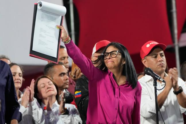 Venezuela's acting President Delcy Rodriguez takes part in a rally holding up a copy of a new law after lawmakers approved legislation opening the nation's oil sector to privatisation, at the Miraflores Palace in Caracas, Venezuela on January 29, 2026. 