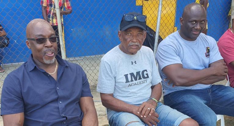 Veteran coach Mike Olivierre (centre) is flanked by Latonel Willams (right), his 1994 Boys Championships Class One 200m/400m runner and Winthorp Graham, the 1984 Boys’ Championships Class One 400m/400m hurdles open winner as they watch proceedings at the