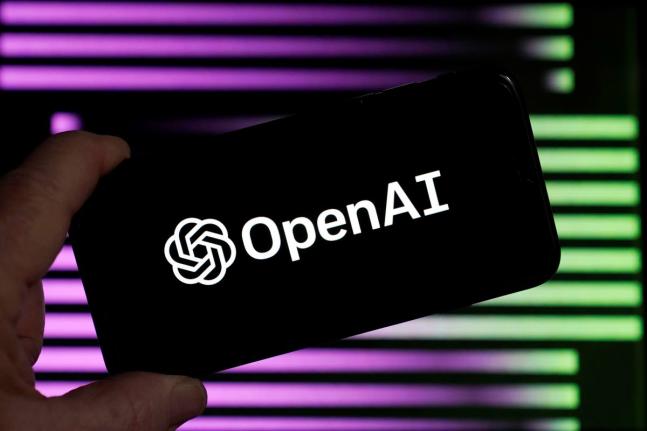 The logo for OpenAI, the maker of ChatGPT, appears on a mobile phone, in New York
