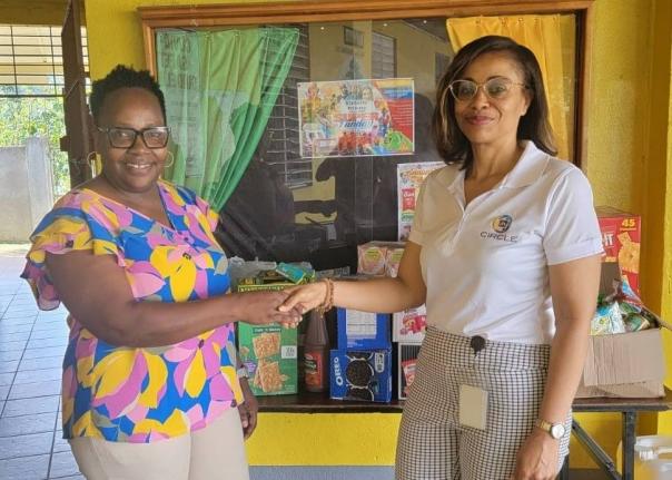  Kareen Dennis (right), secretary of the JN Circle Linstead Chapter, presents breakfast supplies to Annette Steele, principal of Victoria Primary School.